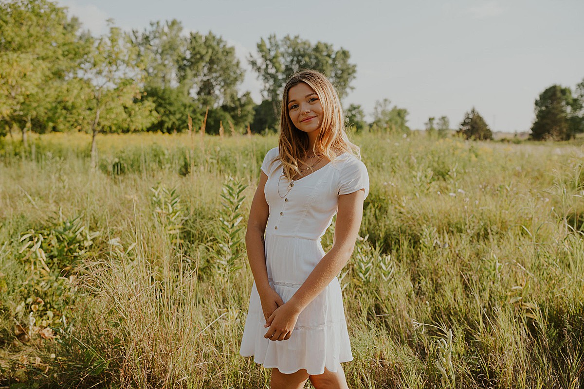 Senior girl in white dress in field