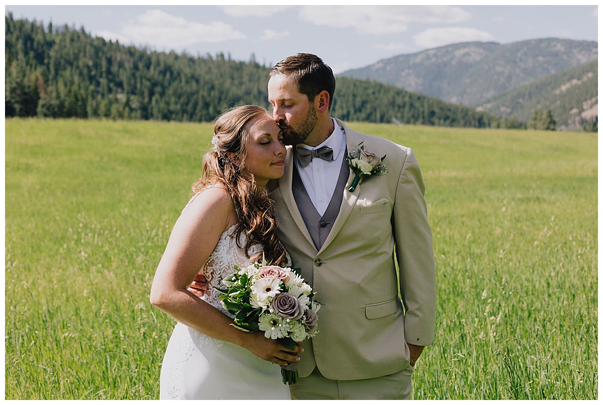 Groom kissing bride at Montana wedding