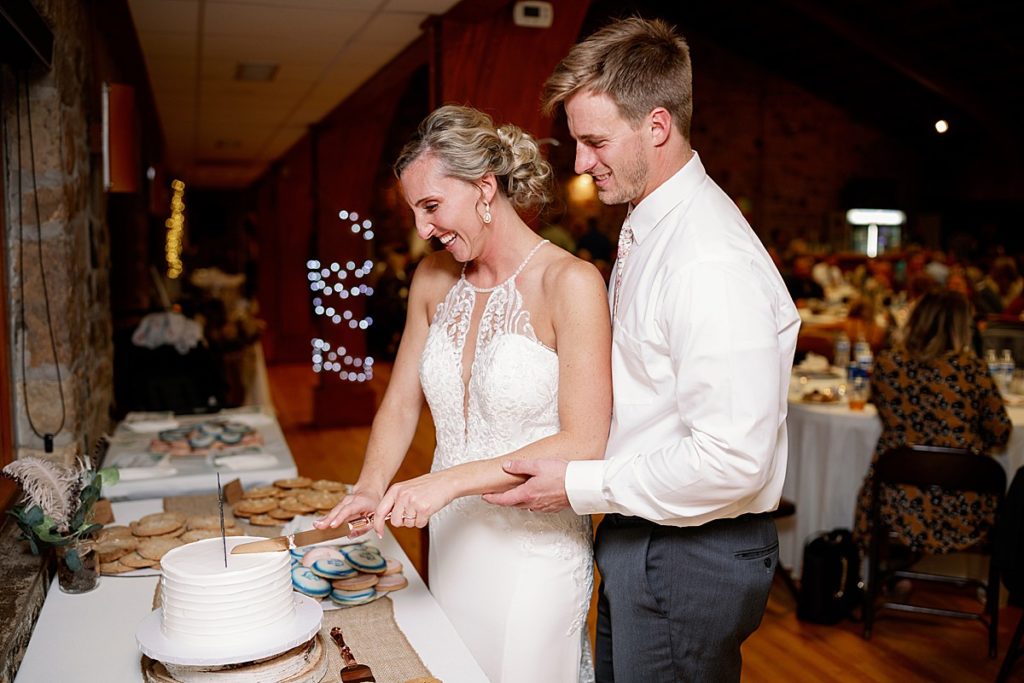 Wisconsin lakeside wedding cake cutting